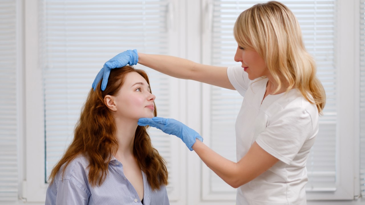 A female medical practioner doctor, nurse attending, checking on a young female patient