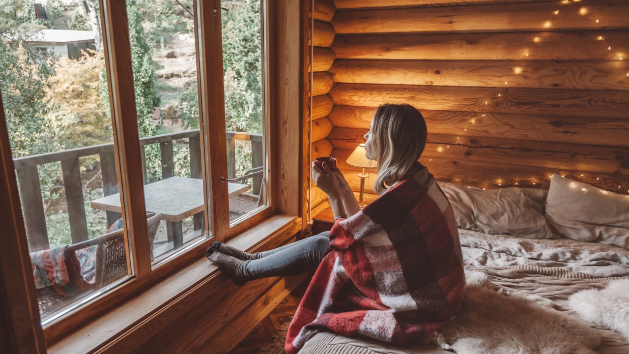 A woman drinking tea, drinking water in a cozy room