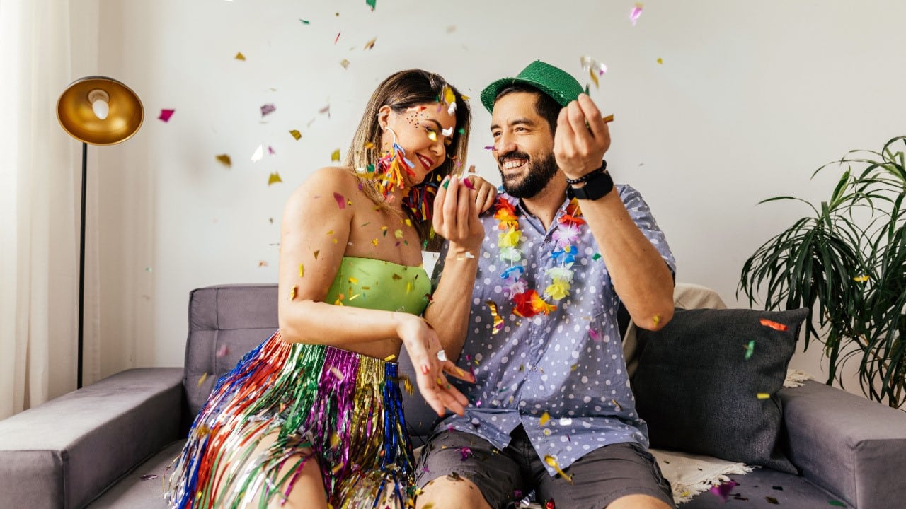 Brazilian Carnival. couple celebrating carnival at home with confetti