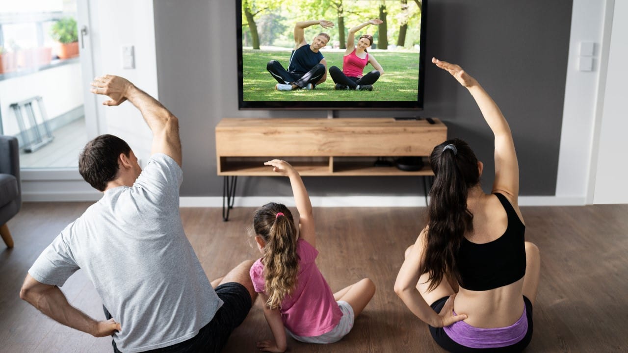 Fit family doing home online fitness program, stretching yoga fitness exercise