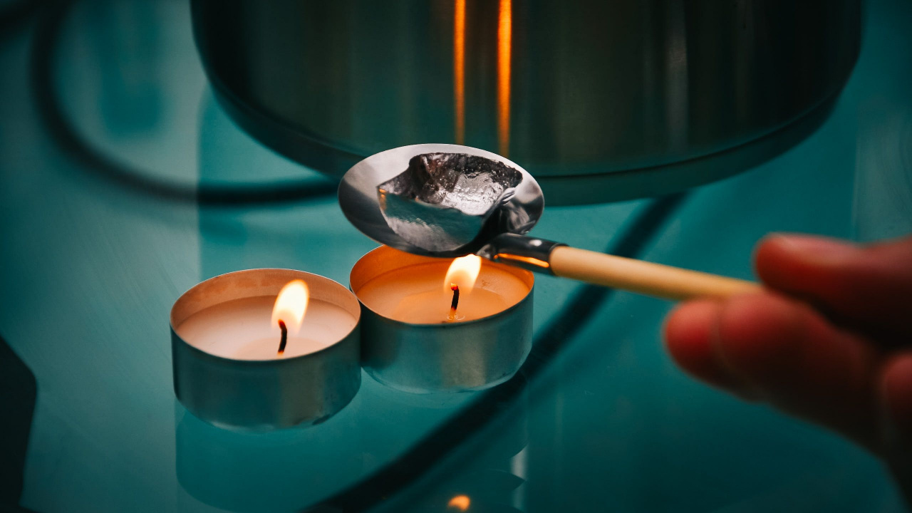 Lead pouring, spoon with lead over a tealight, Bleigießen for Christmas or New Year