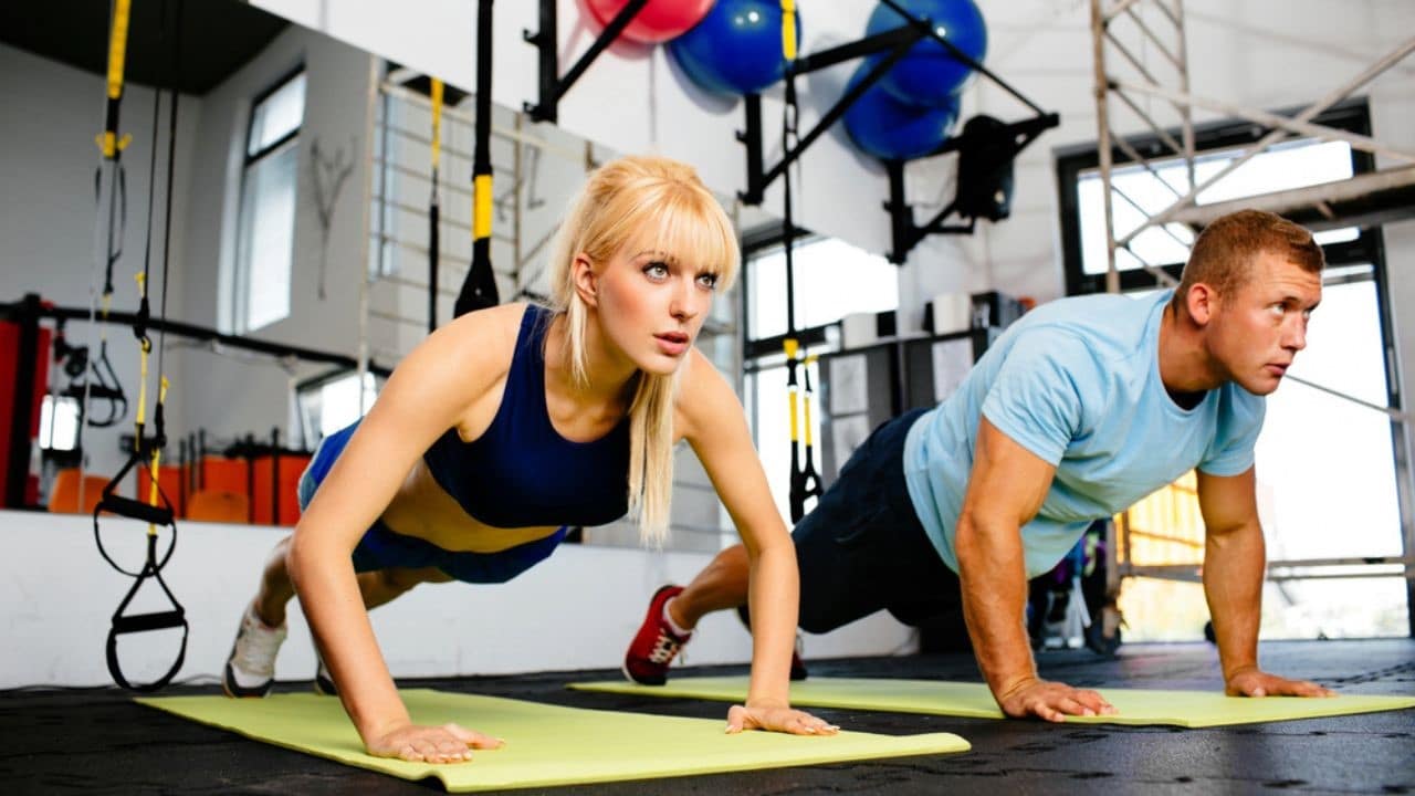 Woman doing pushups with trainer