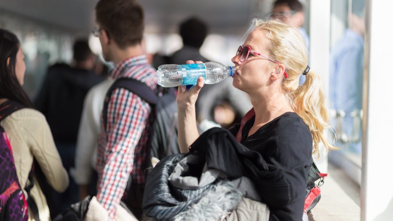 Woman drinking water, stay hydrated