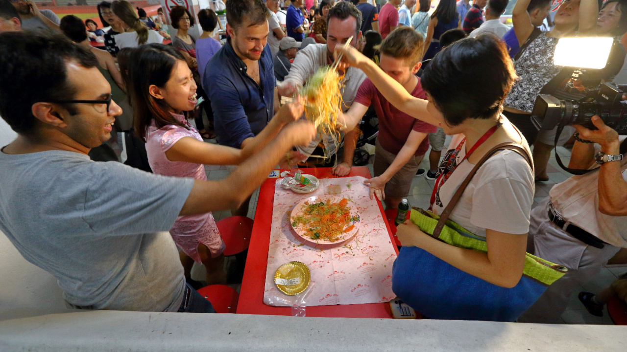 Yusheng Salad Tossing in Singapore, prosperity toss also known as lo hei is a Cantonese-style raw fish salad